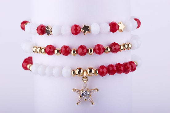 Set de Pulseras "Estrella de Navidad". Cuentas de cristal facetado rojo/blanco y charm de estrella con circonitas. Envío rápido.