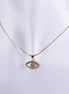 Collar bañado en oro con dije de ojo protector adornado con pavé de zirconias brillantes sobre cadena de serpiente fina.