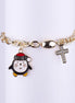 Pulsera de cadena de eslabones dorada con dije de pingüino esmaltado y dije de cruz con pedrería.