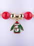 Pulsera elástica con grandes cuentas tipo perla en rojo, verde y blanco, con dije esmaltado de suéter navideño (Ugly Sweater) con diseño de muñeco de nieve.