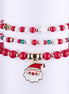 Set de pulseras elásticas navideñas con cuentas opacas rojas y blancas, y un dije esmaltado de Papá Noel dorado.